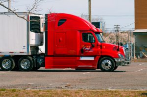 A red reefer unit truck parked.