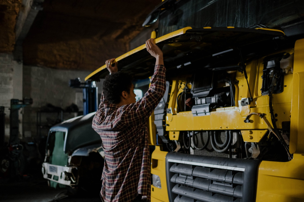 A truck mechanic repairing a transport truck.