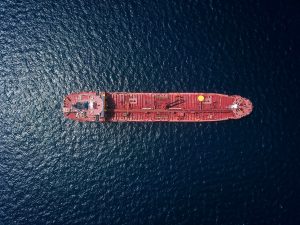 Showing image of a container ship out on the ocean.