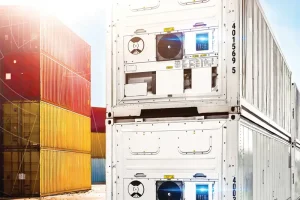 Stacked refrigerated containers in a port with data overlay.